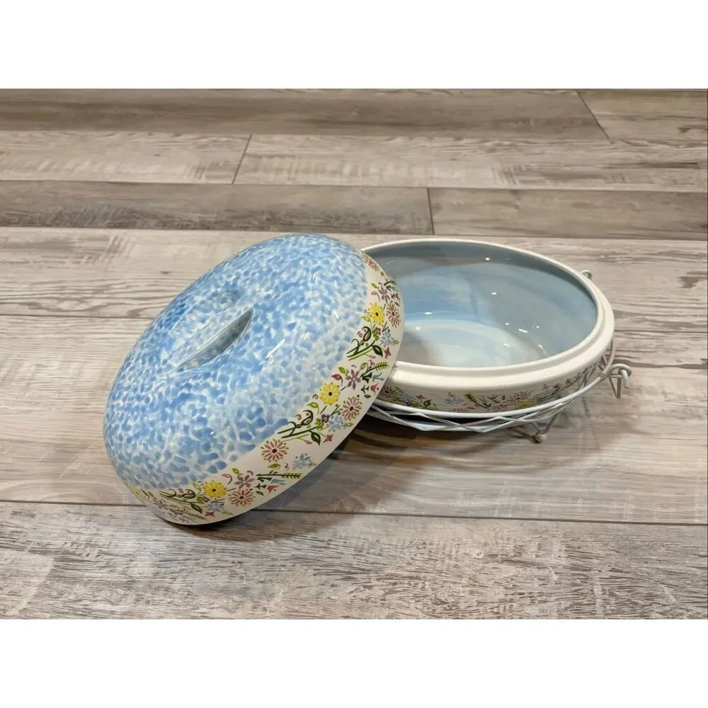 Temp-tations Ovenware by Tara Blue oval covered casserole dish with a metal stan